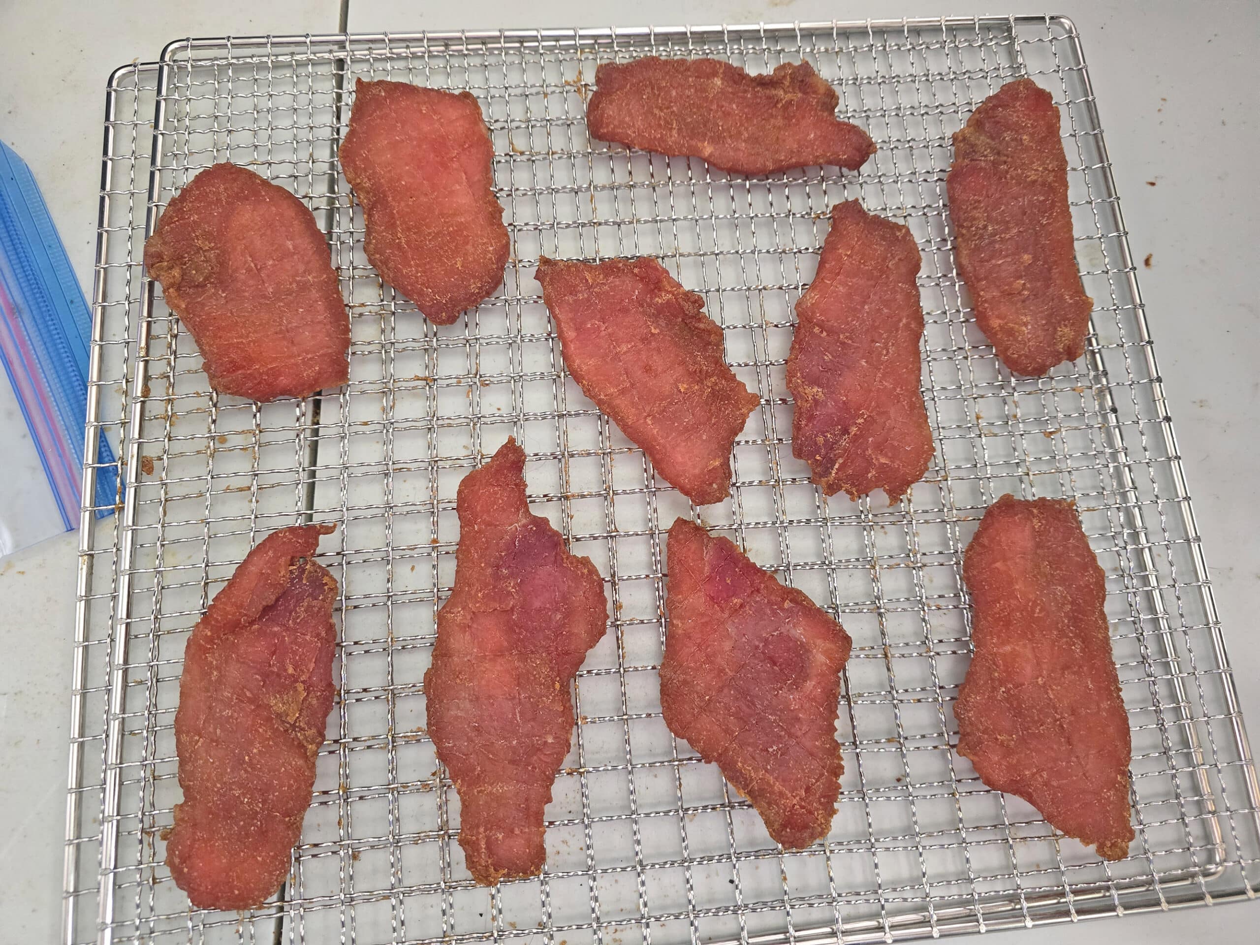 A wire rack with the finished back bacon jerky