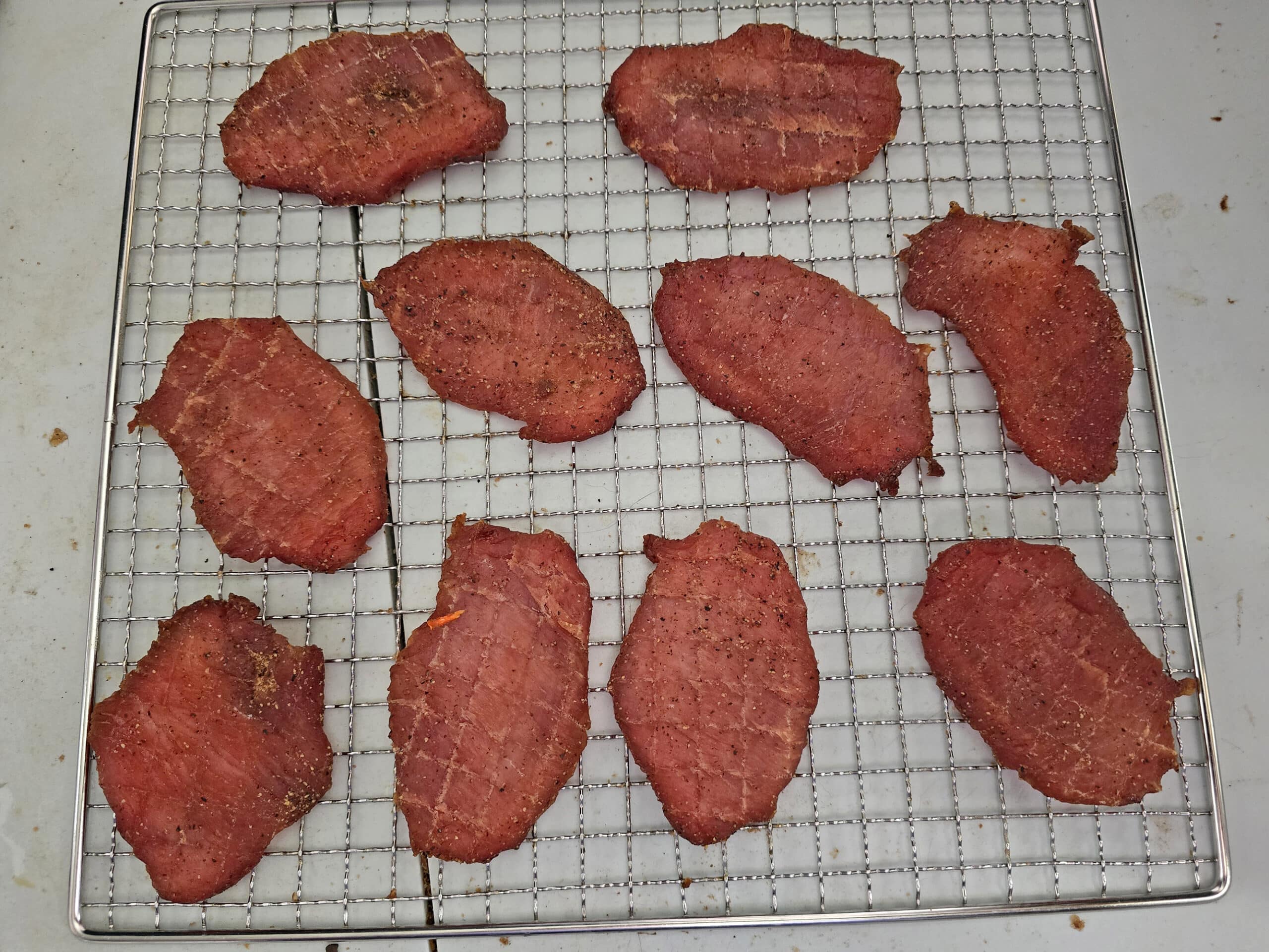 A finished batch of basic pork loin jerky on a wire rack.