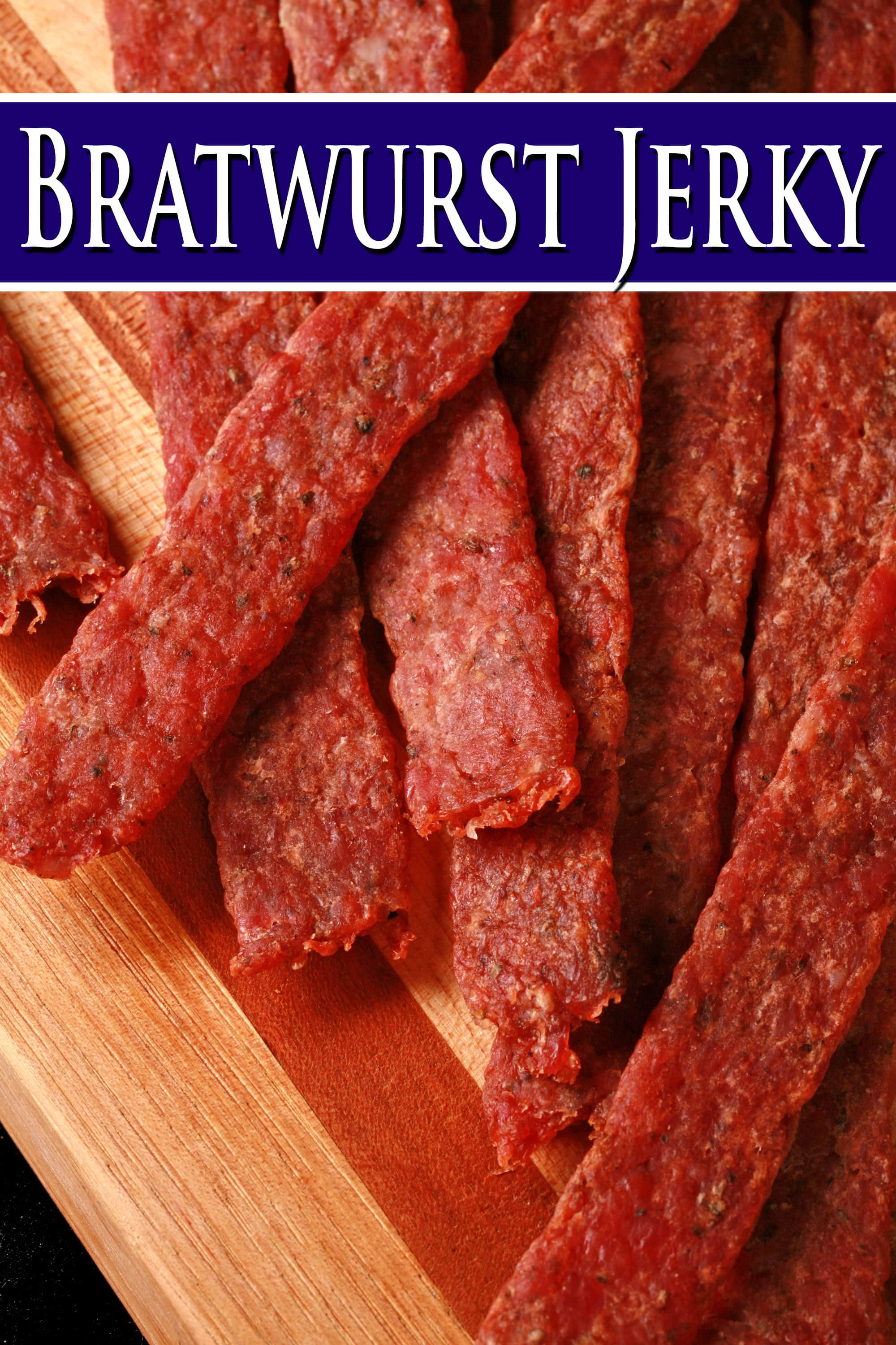 Several strips of bratwurst flavoured ground pork jerky on a cutting board. Overlaid text says bratwurst jerky.