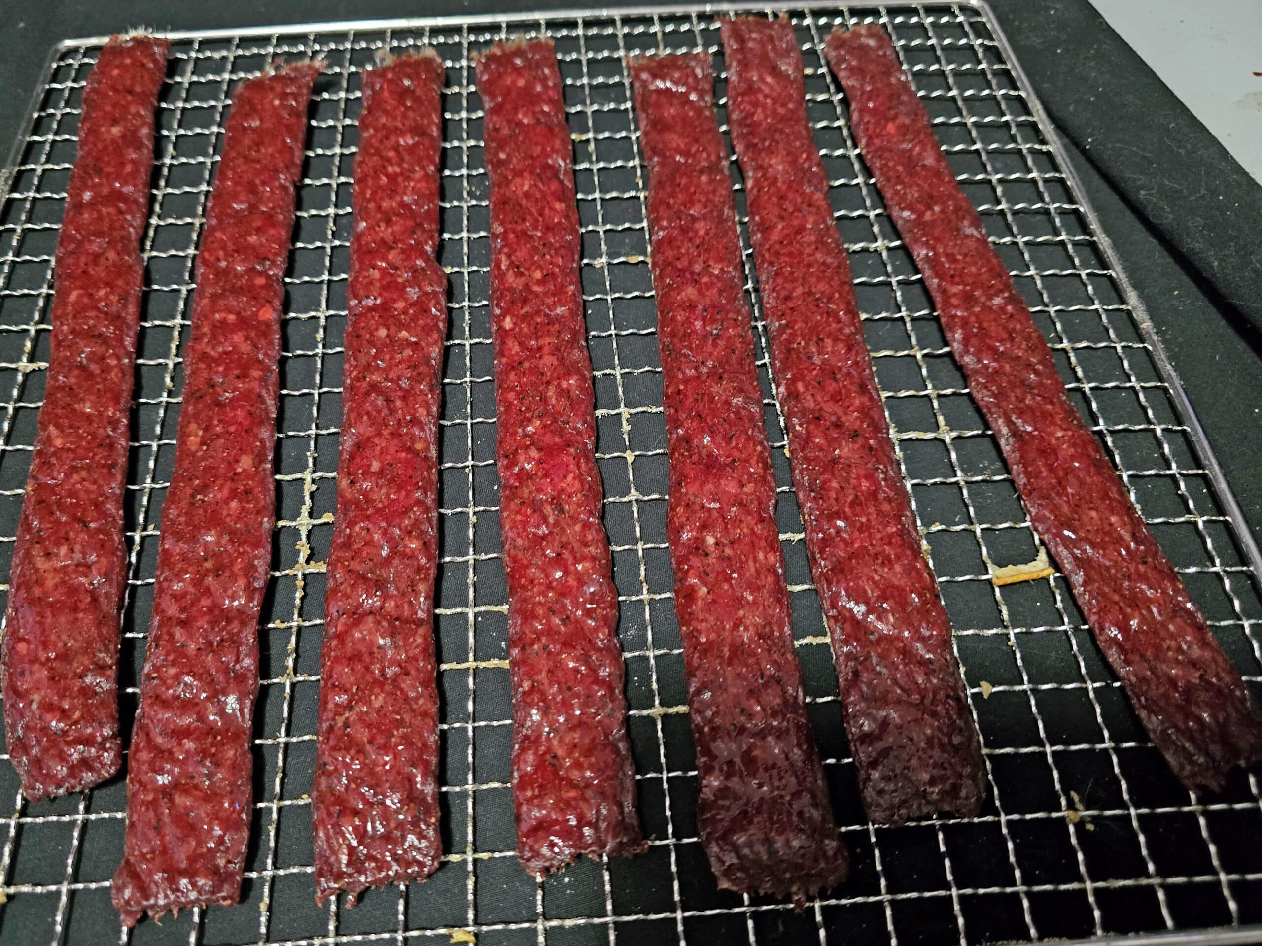 A tray of homemade peppered beef jerky.