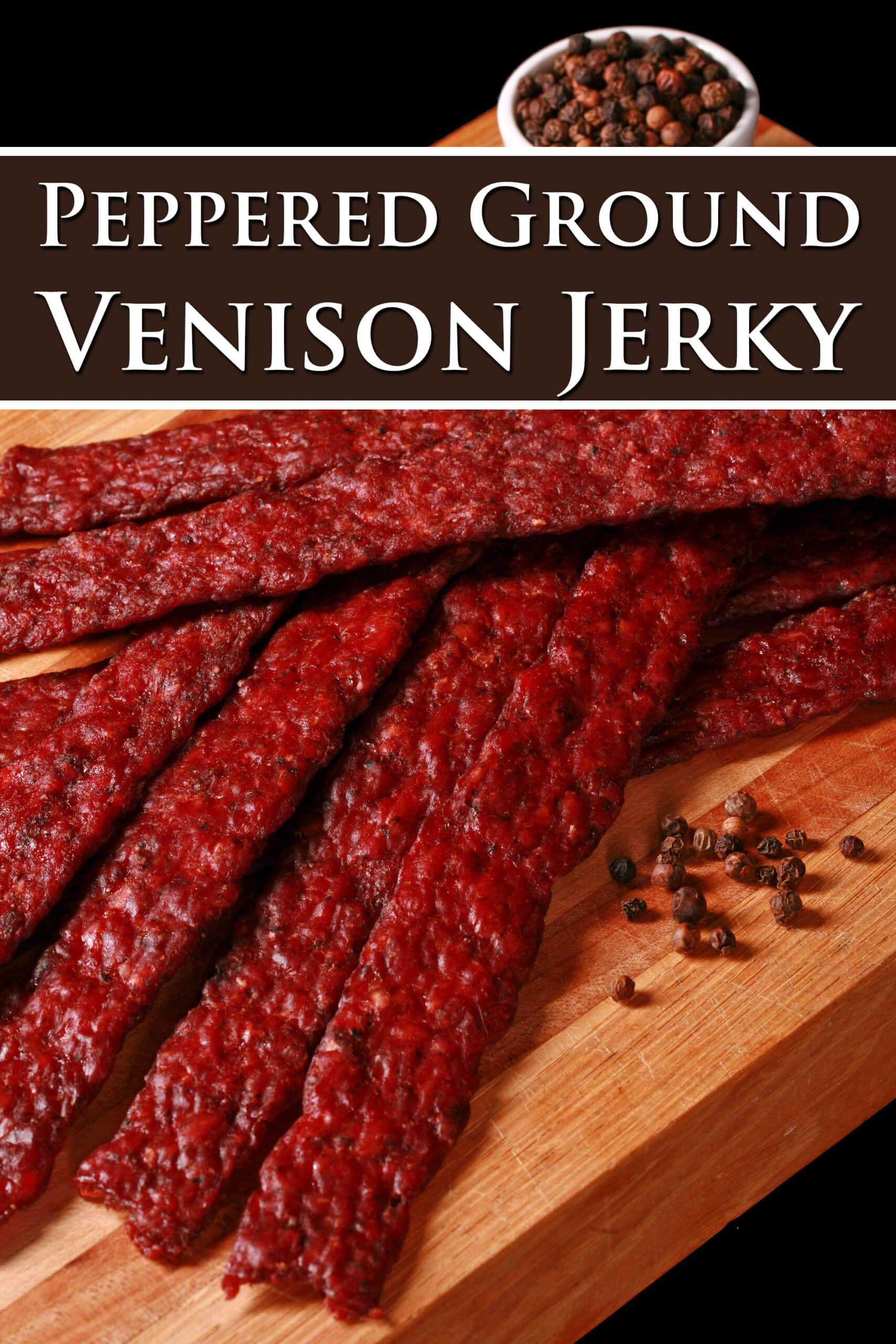 Peppered ground deer jerky strips on a wooden cutting board. Overlaid text says peppered ground venison jerky.