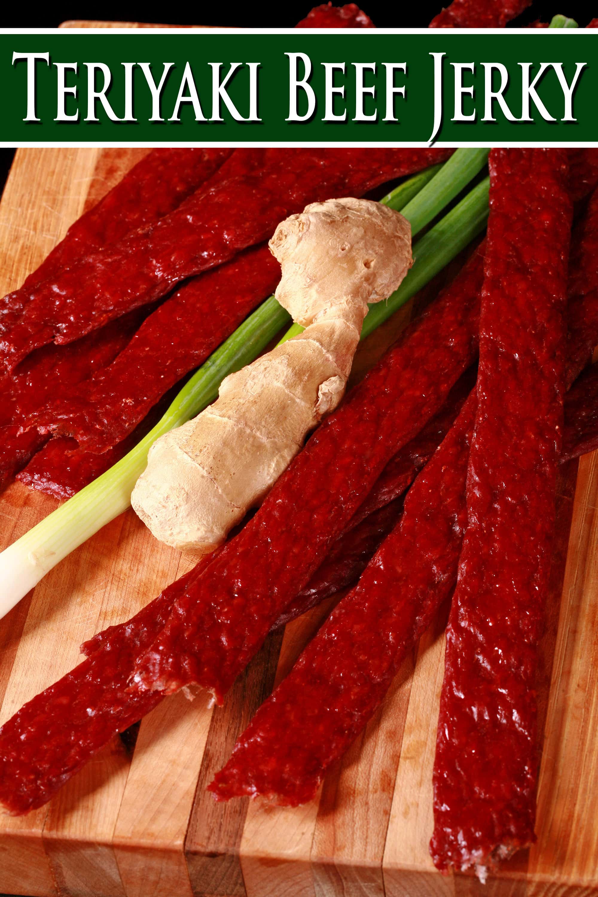 Several strips of teriyaki ground beef jerky on a cutting board with a knob of ginger and some green onions. Overlaid text says teriyaki beef jerky.