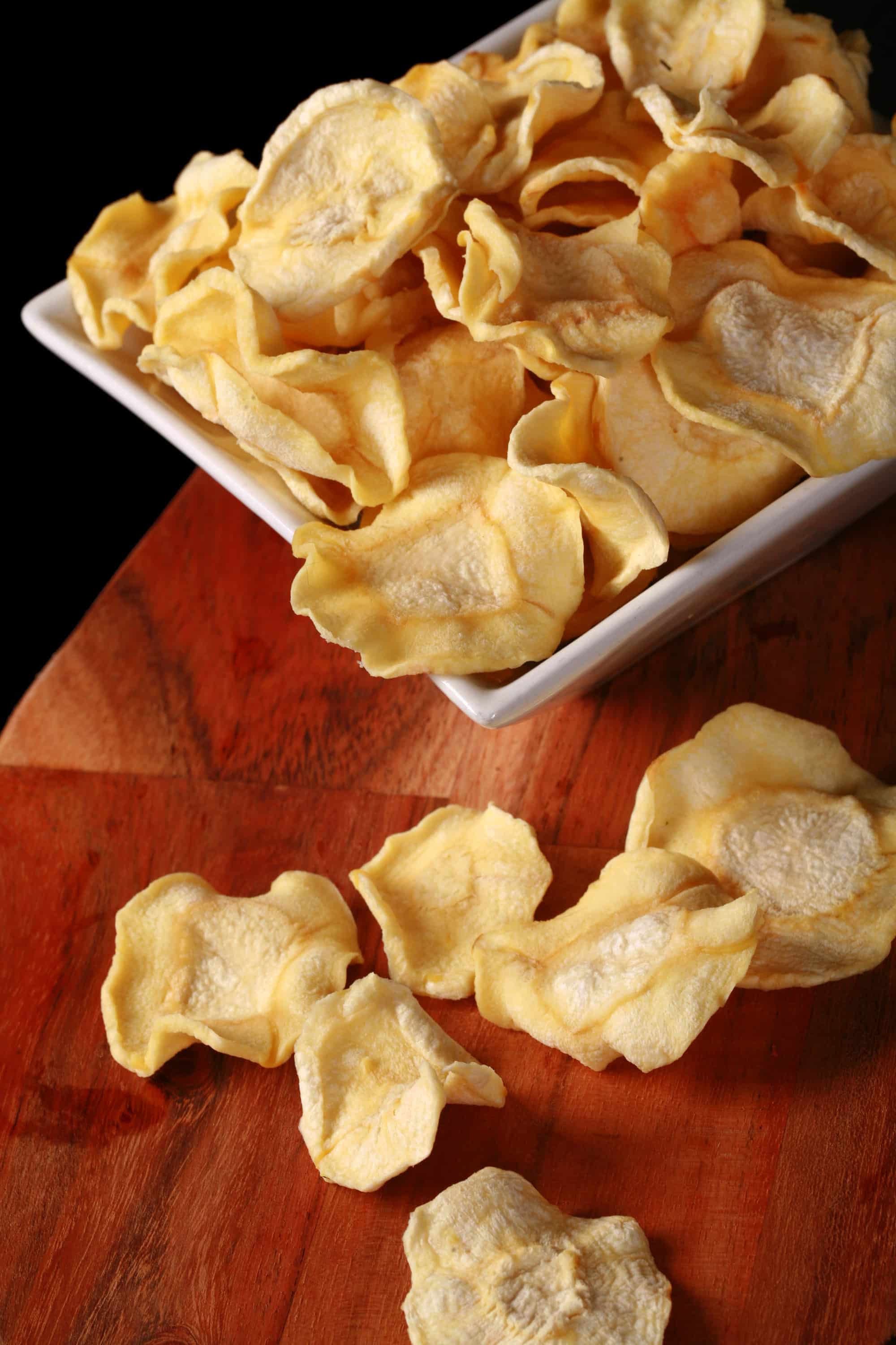 A bowl of crunchy dried parsnip chips.