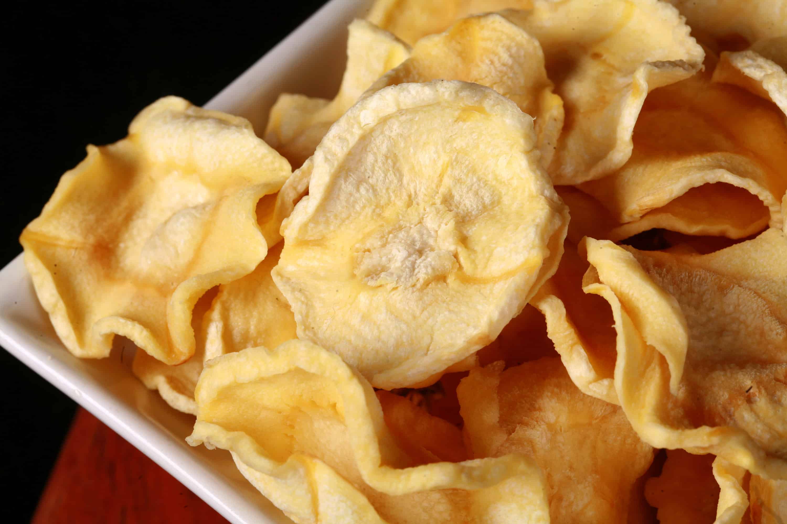 A bowl of crunchy dried parsnip chips.