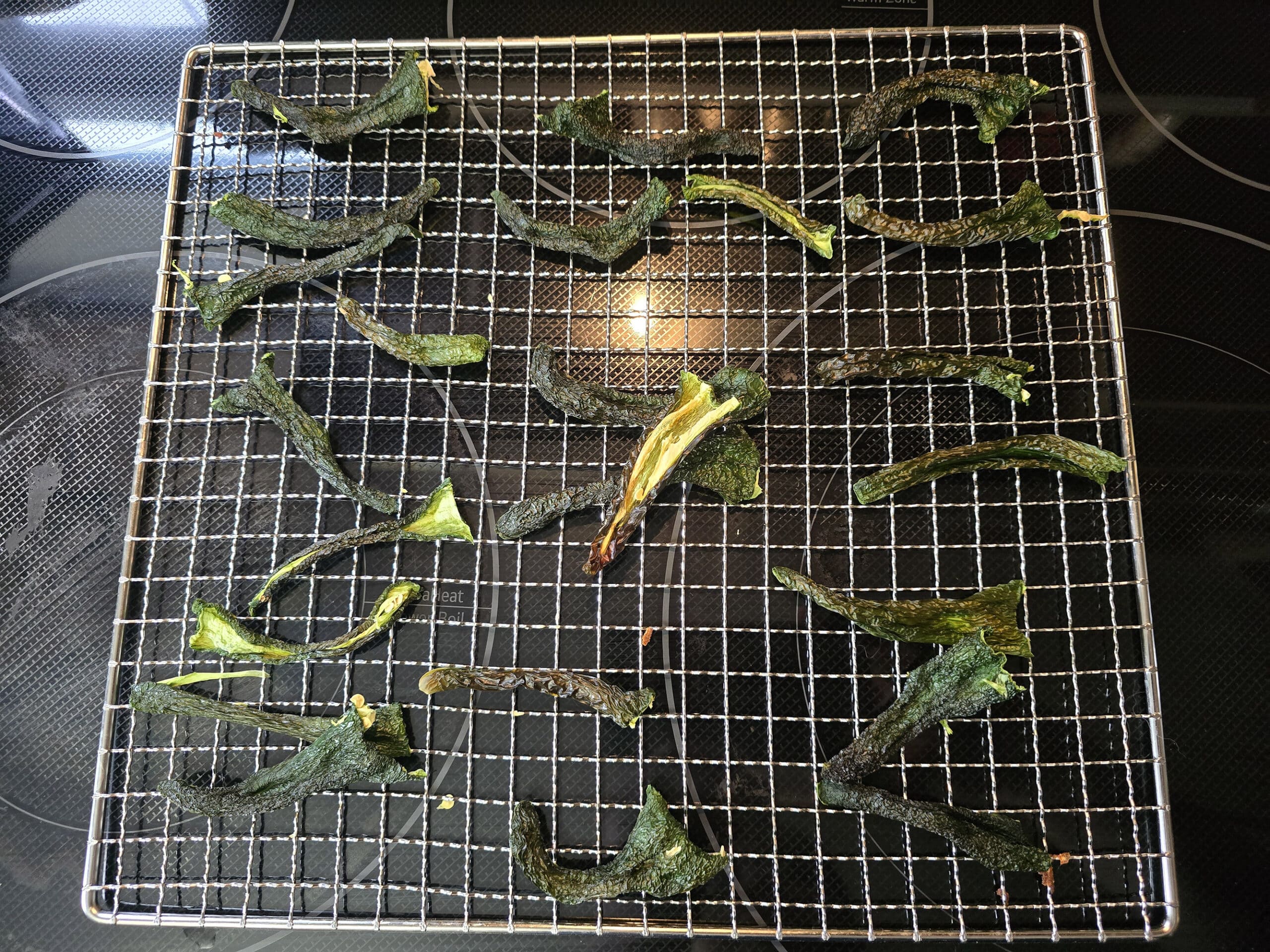 a rack of fully dried jalapeno halves.