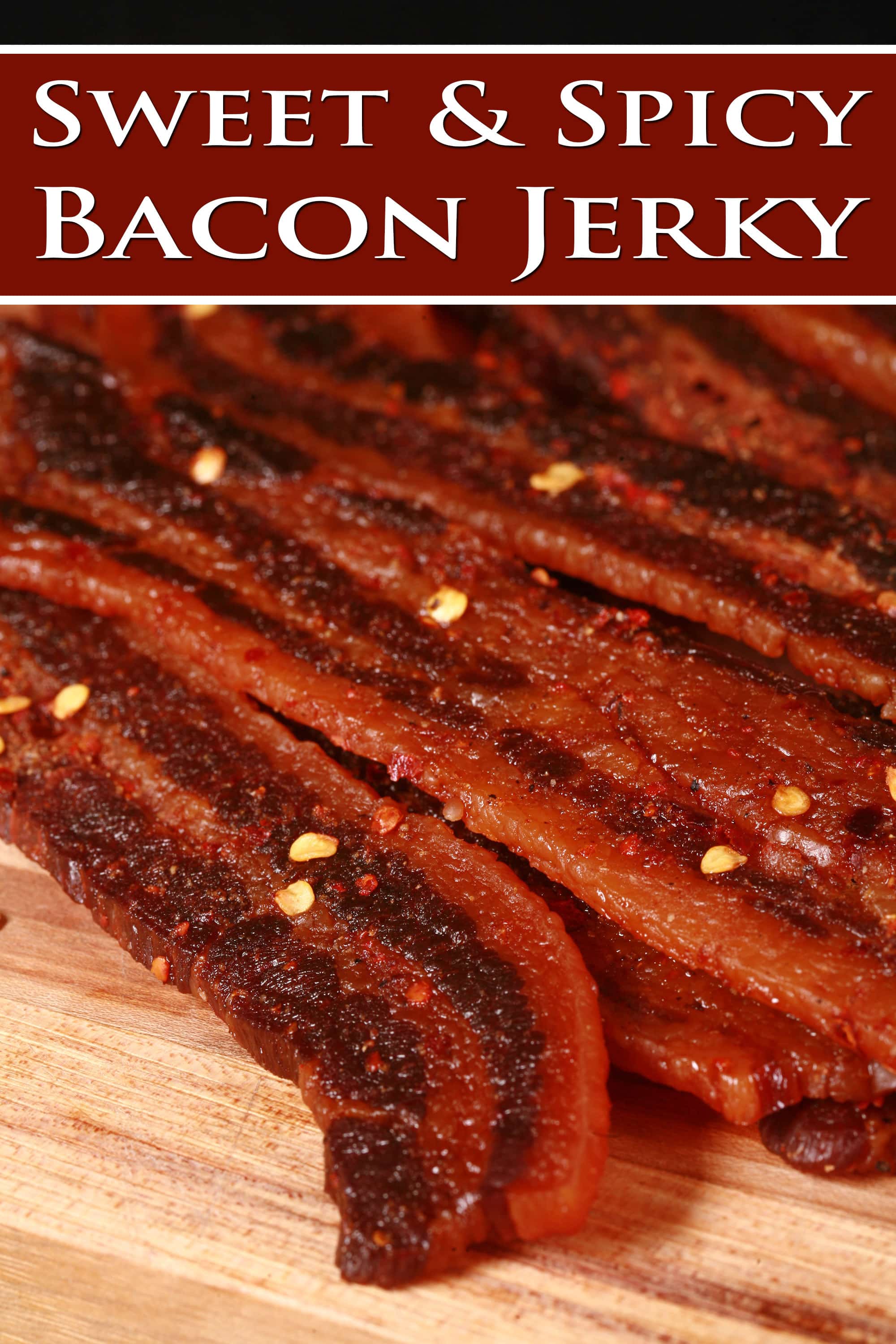 A pile of sweet and spicy homemade bacon jerky on a wooden cutting board. Overlaid text says sweet and spicy bacon jerky.