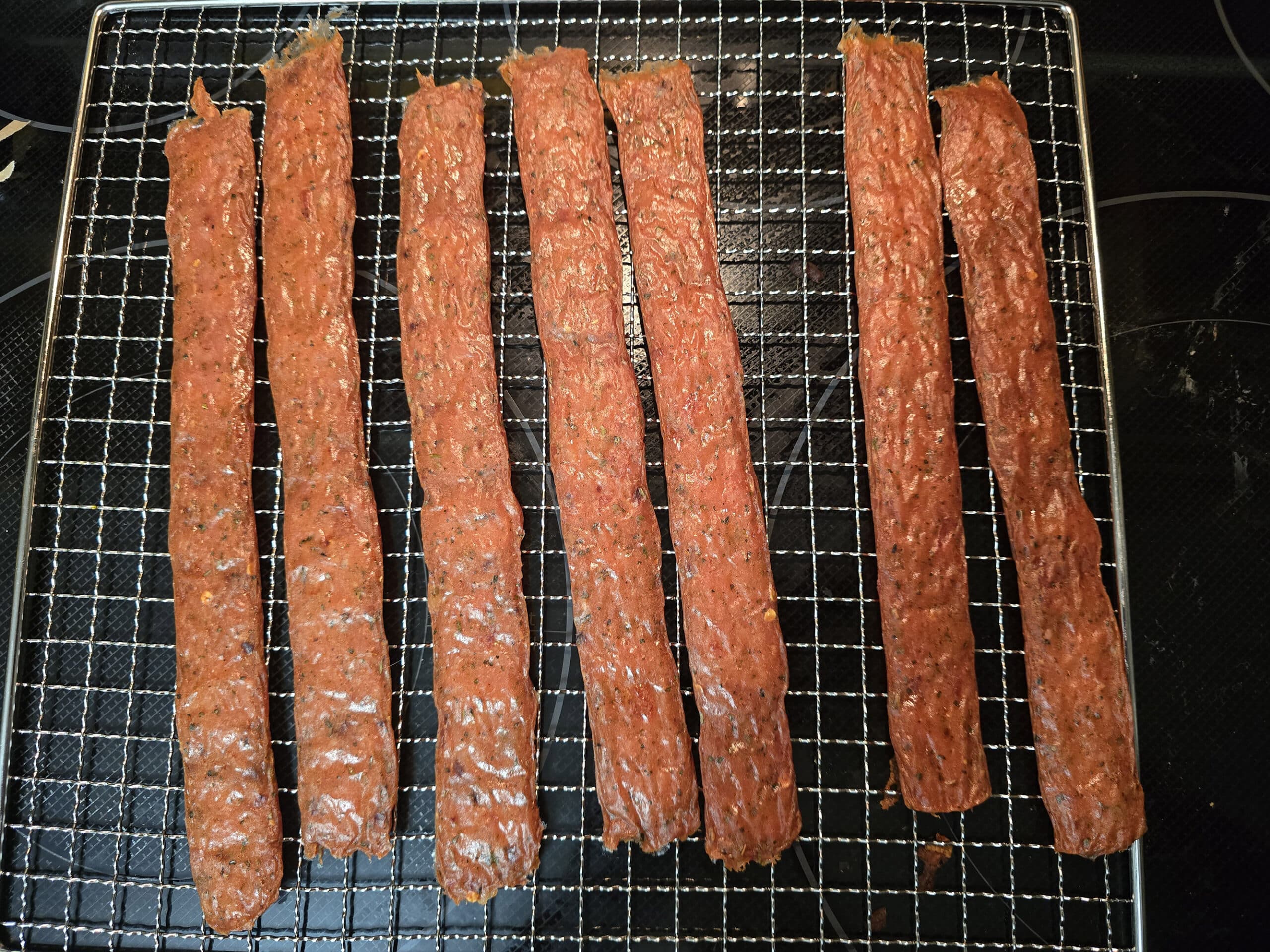 A tray of finished pizza jerky strips.