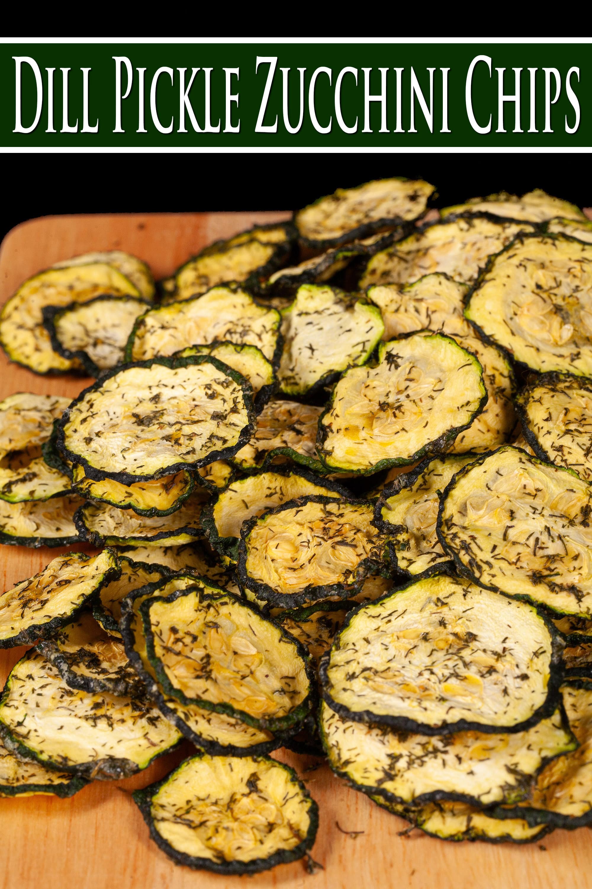 A pile of homemade dill pickle zucchini chips on a cutting board. Overlaid text says dill pickle zucchini chips.
