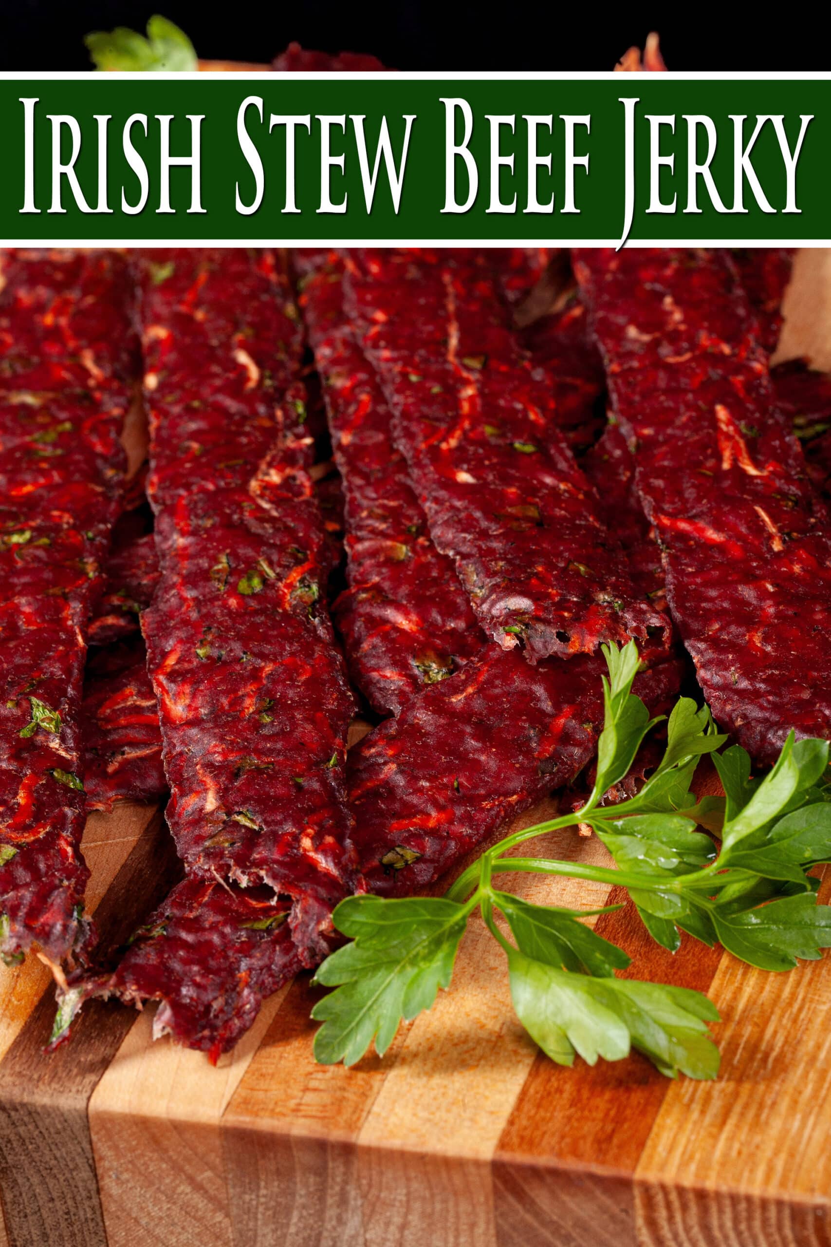 Several strips of Irish Stew jerky on a cutting board, with carrots, turnips, and parsley visible in the homemade beef jerky. Overlaid text says Irish Stew beef jerky.