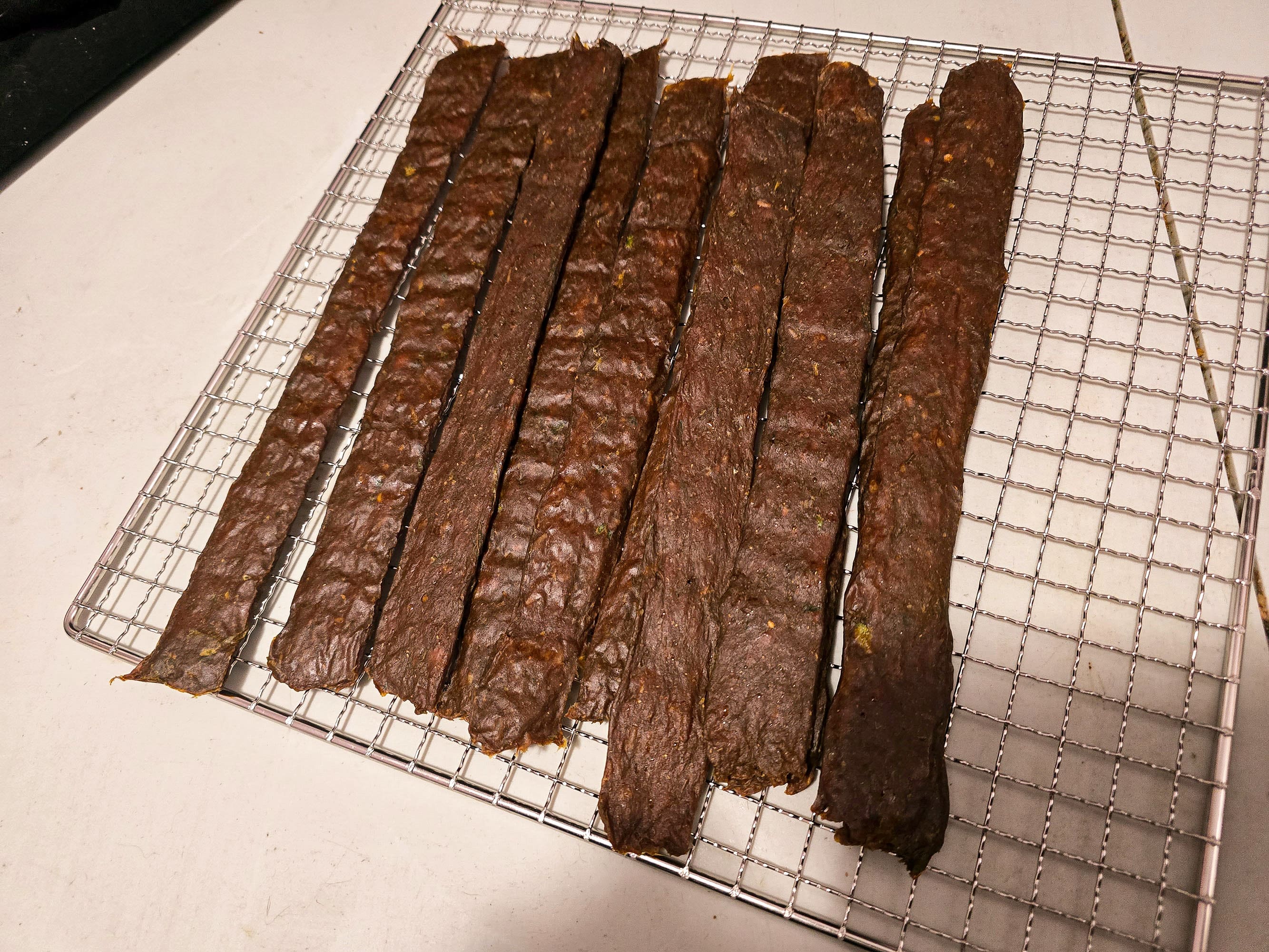A rack of finished Jamaican curry jerky.